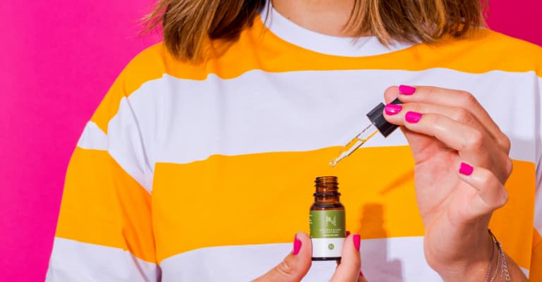 Model with 500mg cbd oil bottle and dropper