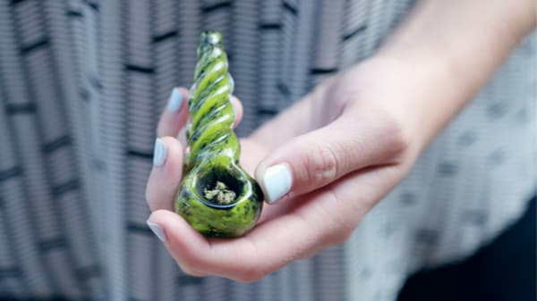 filling up a bowl with weed
