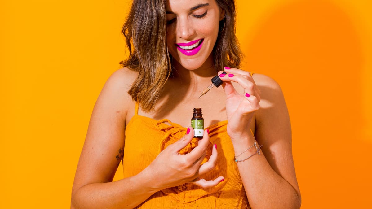 Model with a bottle of nature and bloom cbd oil